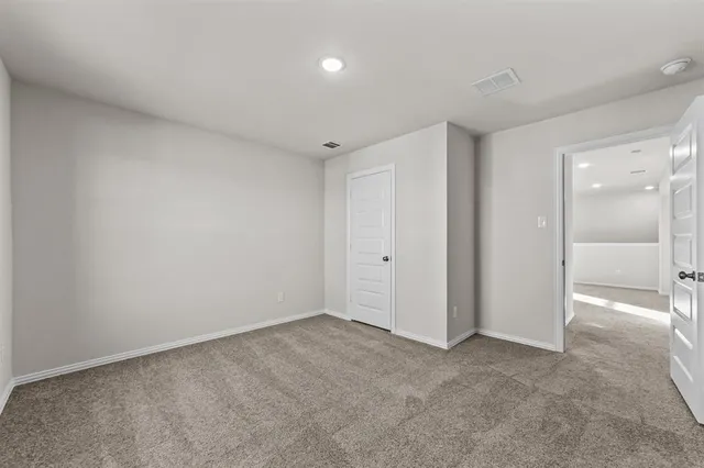 a view of an empty room and a bathroom