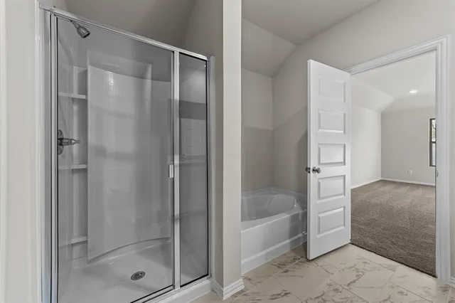 a bathroom with a glass shower door