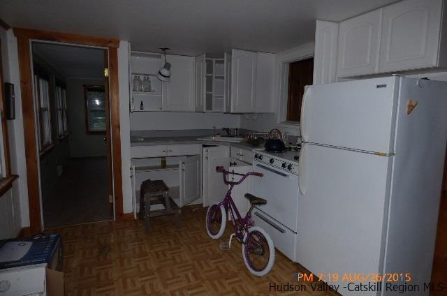 497 County Route 56 Maplecrest, NY 12454 - Photo 2 of 9 a kitchen with a refrigerator and a stove top oven