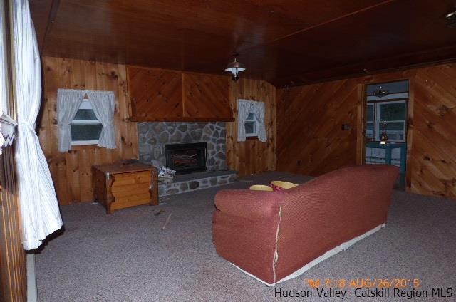 497 County Route 56 Maplecrest, NY 12454 - Photo 3 of 9 a living room with furniture and a fireplace