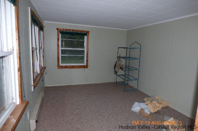 497 County Route 56 Maplecrest, NY 12454 - Photo 5 of 9 an empty room with a window