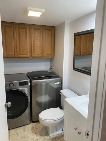 a bathroom with a toilet a sink and a window