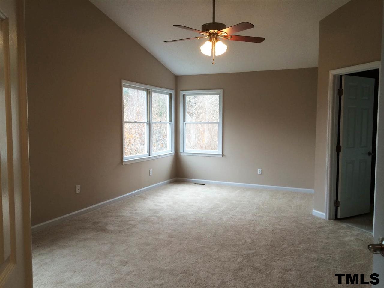 1607 Edenderry Court Garner, NC 27529 - Photo 11 of 22 an empty room with windows and fan