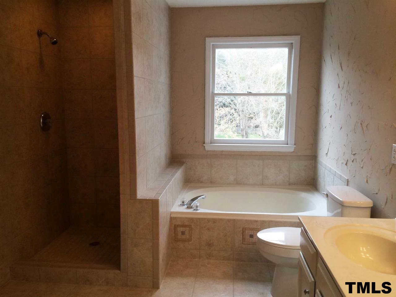 1607 Edenderry Court Garner, NC 27529 - Photo 14 of 22 a bath tub sitting in a bathroom next to a toilet