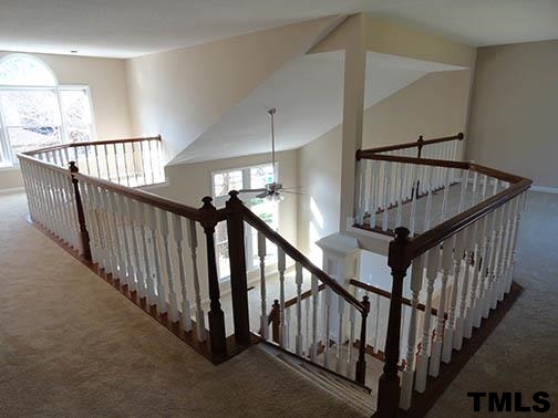 1607 Edenderry Court Garner, NC 27529 - Photo 17 of 22 a view of staircase with wooden floor and white walls