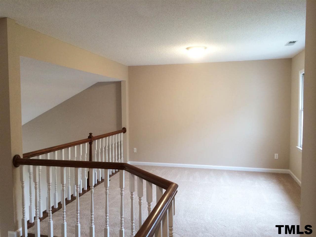 1607 Edenderry Court Garner, NC 27529 - Photo 18 of 22 a view of staircase with railing and a window