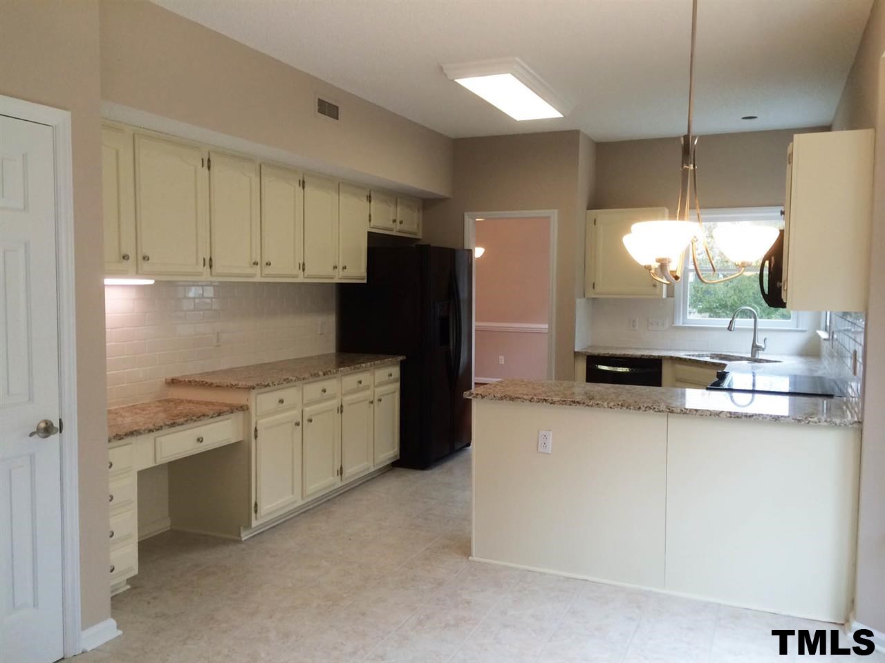 1607 Edenderry Court Garner, NC 27529 - Photo 5 of 22 a kitchen with a sink stove and refrigerator