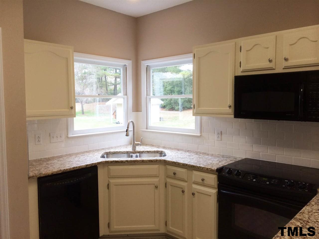 1607 Edenderry Court Garner, NC 27529 - Photo 6 of 22 a kitchen with granite countertop cabinets sink and window