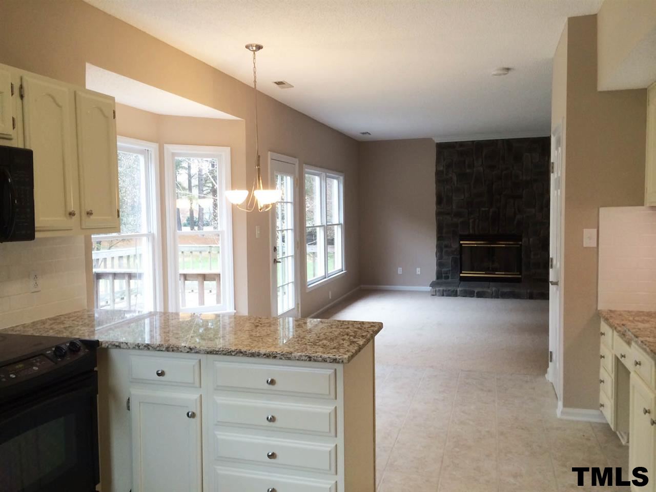 1607 Edenderry Court Garner, NC 27529 - Photo 7 of 22 a kitchen with granite countertop a stove a refrigerator and a sink