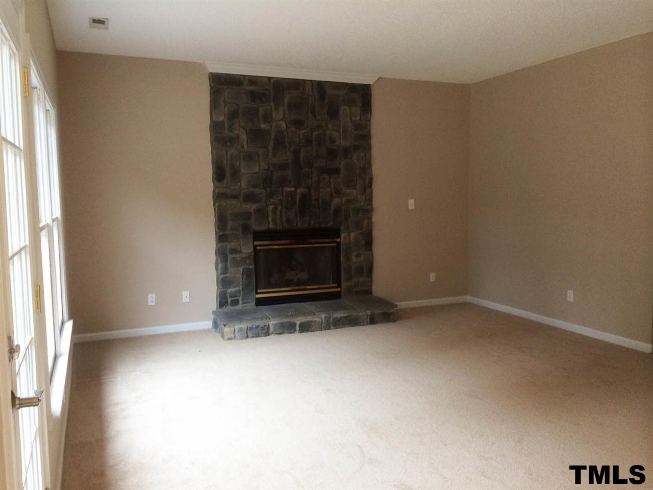 1607 Edenderry Court Garner, NC 27529 - Photo 8 of 22 a view of empty room with a fireplace