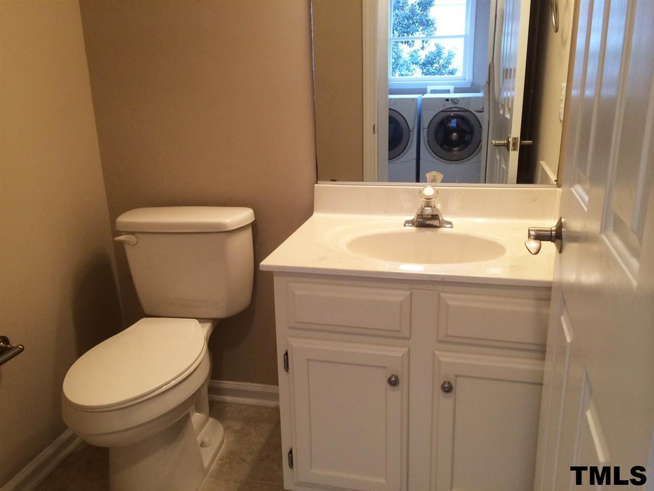 1607 Edenderry Court Garner, NC 27529 - Photo 10 of 22 a bathroom with a sink a toilet and a mirror