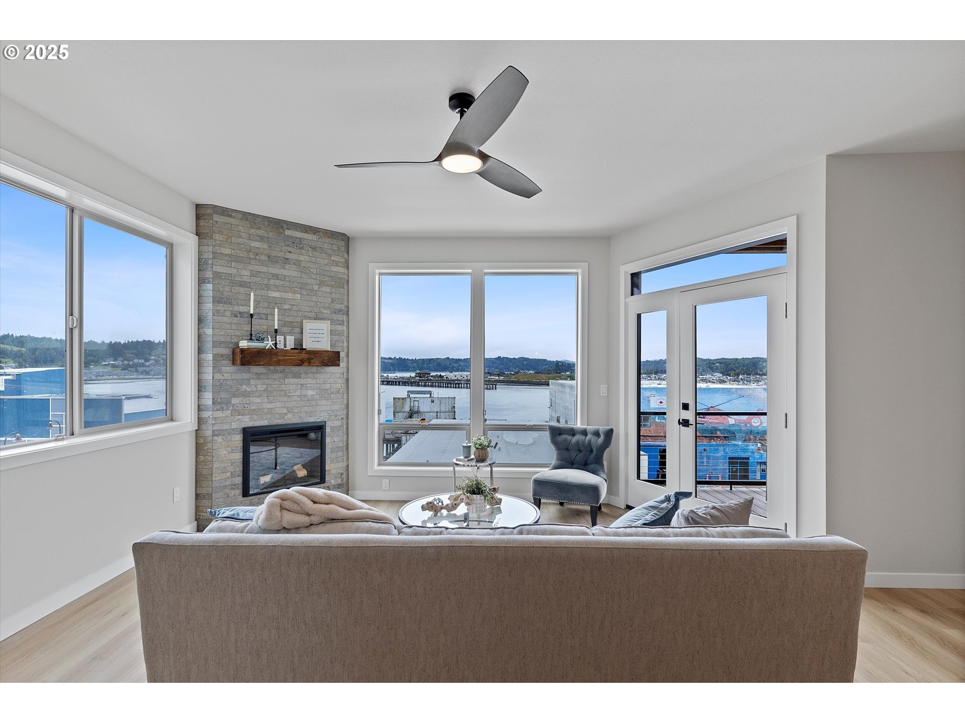 811 Southwest 13th Street Newport, OR 97365 - Photo 11 of 45 a living room with fireplace furniture and a floor to ceiling window