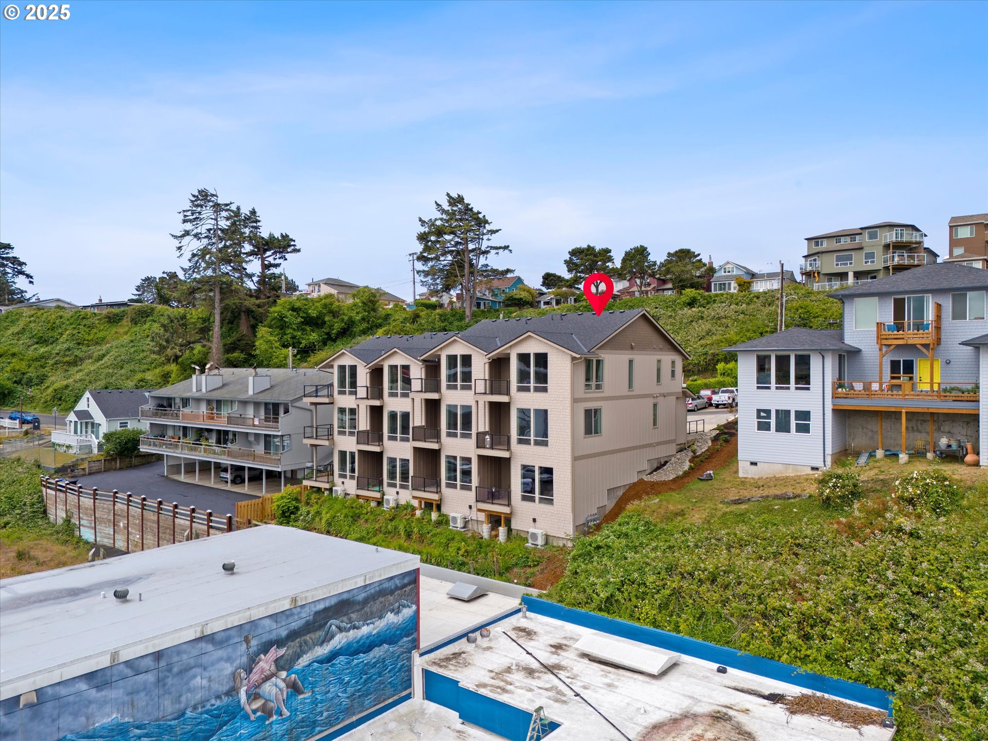 811 Southwest 13th Street Newport, OR 97365 - Photo 43 of 45 a large building with a big yard and large trees