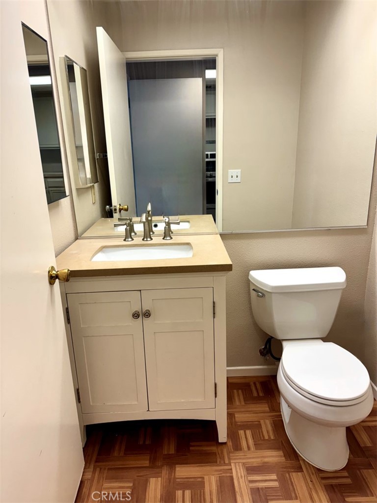 14152 Foothill Boulevard, Unit 35 Sylmar, CA 91342 - Photo 12 of 30 a bathroom with a granite countertop toilet sink and mirror