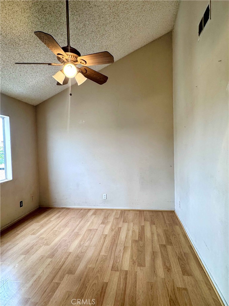 14152 Foothill Boulevard, Unit 35 Sylmar, CA 91342 - Photo 14 of 30 a view of room with a window and wooden floor