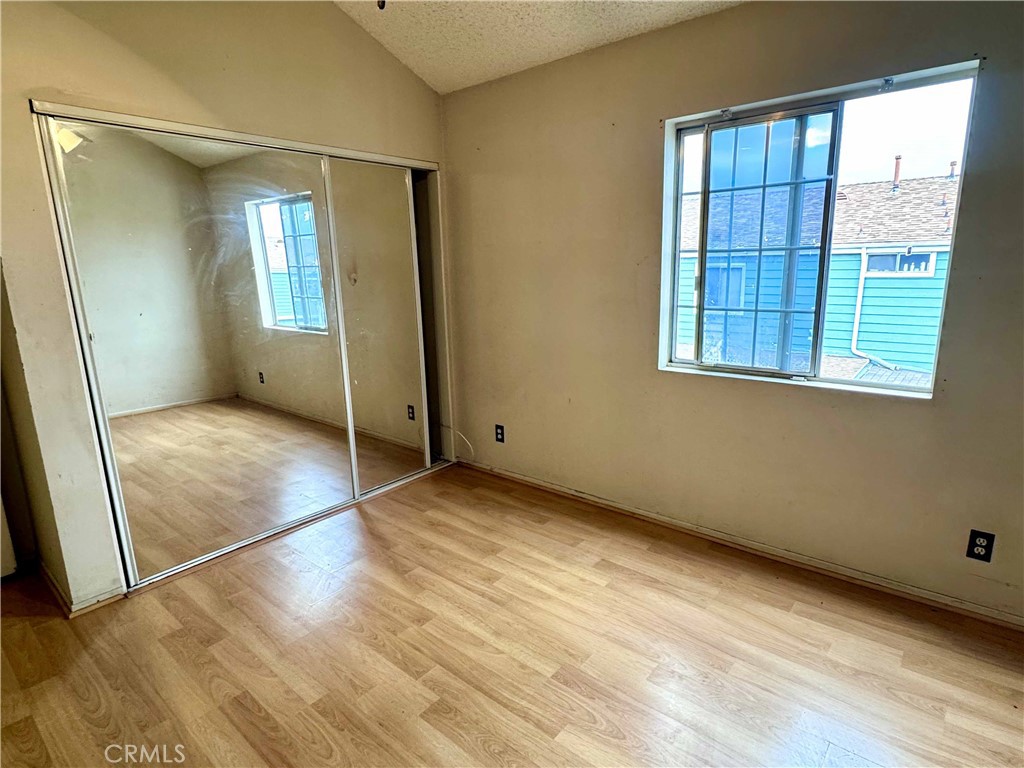 14152 Foothill Boulevard, Unit 35 Sylmar, CA 91342 - Photo 15 of 30 an empty room with wooden floor and windows