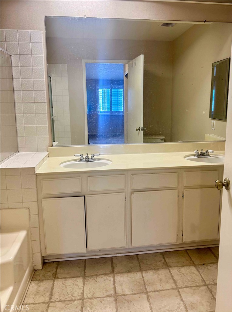 14152 Foothill Boulevard, Unit 35 Sylmar, CA 91342 - Photo 23 of 30 a bathroom with a sink and a mirror