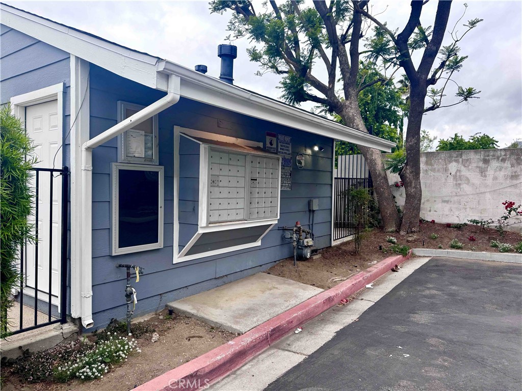 14152 Foothill Boulevard, Unit 35 Sylmar, CA 91342 - Photo 28 of 30 a wooden bench sitting in front of a building