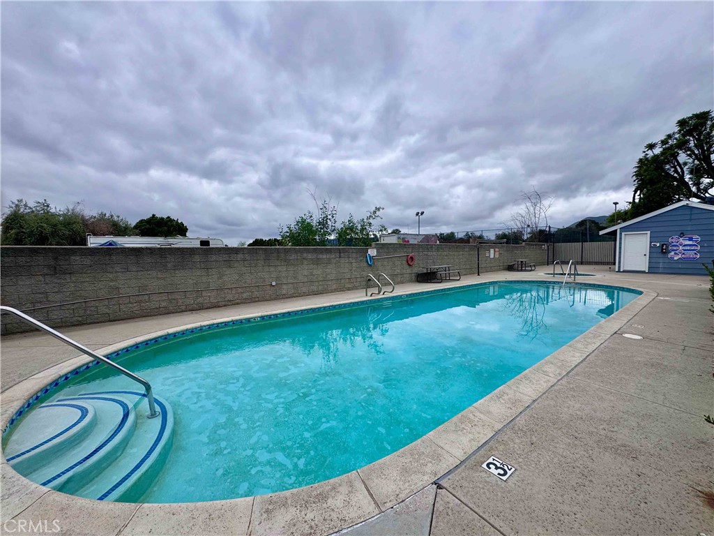 14152 Foothill Boulevard, Unit 35 Sylmar, CA 91342 - Photo 29 of 30 a view of a swimming pool with a yard