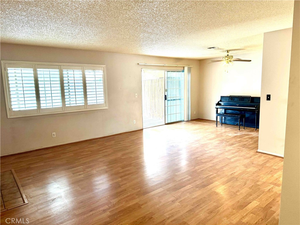 14152 Foothill Boulevard, Unit 35 Sylmar, CA 91342 - Photo 4 of 30 an empty room with wooden floor and windows
