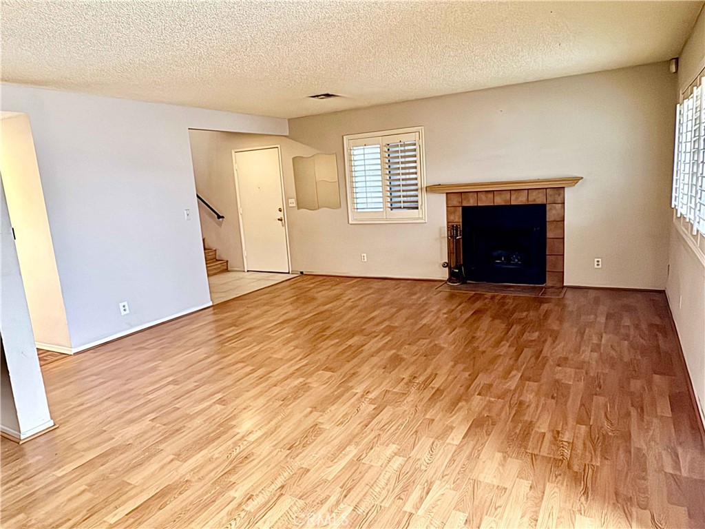 14152 Foothill Boulevard, Unit 35 Sylmar, CA 91342 - Photo 7 of 30 a view of an empty room with wooden floor and a window