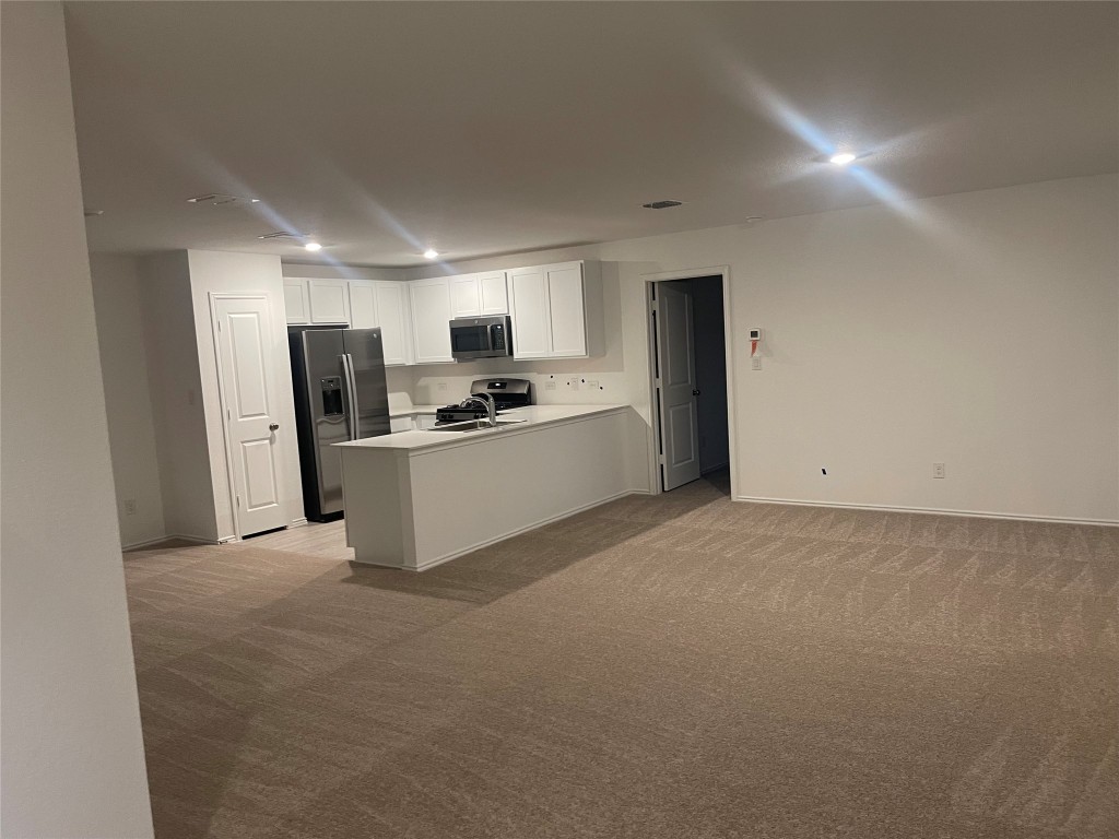 170 Sormonne Loop Kyle, TX 78640 - Photo 2 of 3 a view of a kitchen with refrigerator and microwave