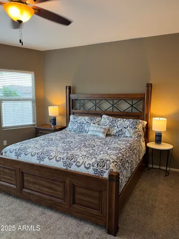 a bedroom with a bed and a chandelier