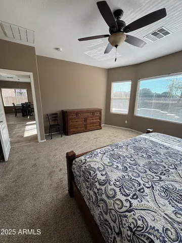 a bedroom with a bed and a large window