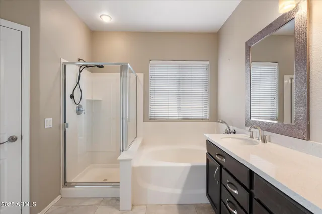 a bathroom with a tub sink and shower