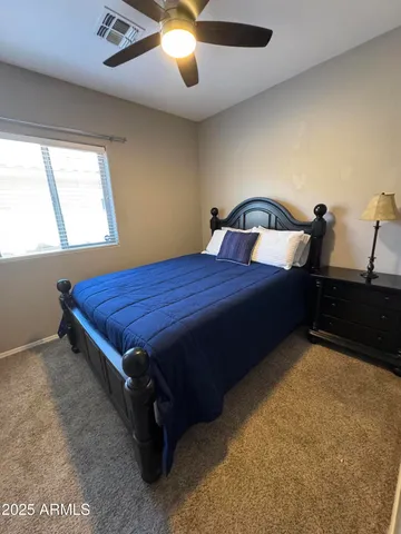 a bed sitting in a bedroom next to a window