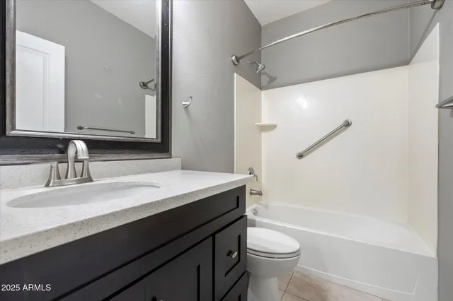 a bathroom with a sink a toilet a mirror and shower