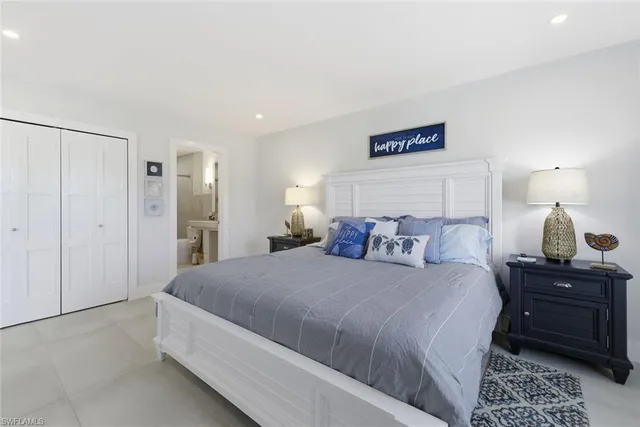 a bedroom with a bed and a lamp