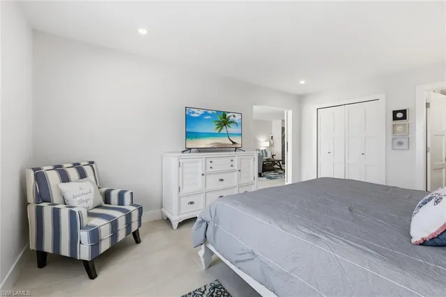 a bedroom with a bed and a couch