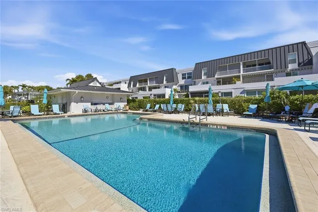 a view of swimming pool with outdoor seating