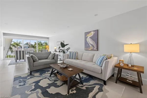 a living room with furniture a couch and a window