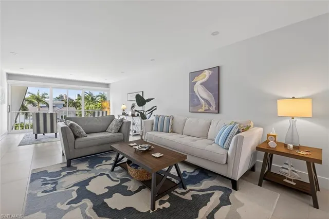 a living room with furniture a couch and a window