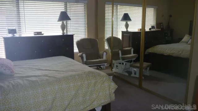 a bedroom with a bed and windows