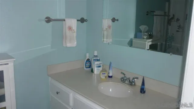 a bathroom with a sink and mirror