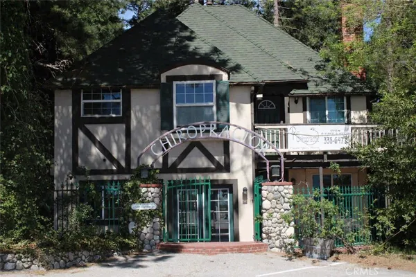 a front view of a house with plants