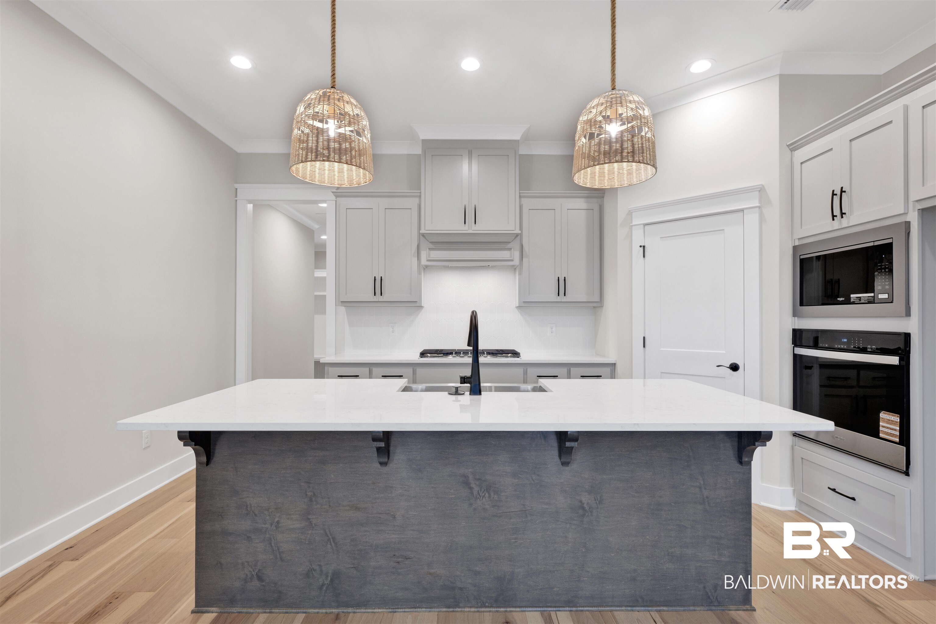 27382 Patch Pl Loop Daphne, AL 36526 - Photo 14 of 31 Kitchen with a kitchen breakfast bar, light stone counters, stainless steel appliances, a kitchen island with sink, and light wood-style flooring