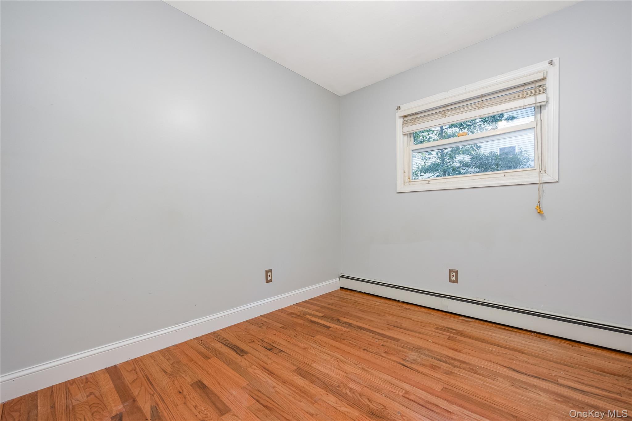 16 Hillside Road Farmingville, NY 11738 - Photo 12 of 22 a view of empty room with wooden floor