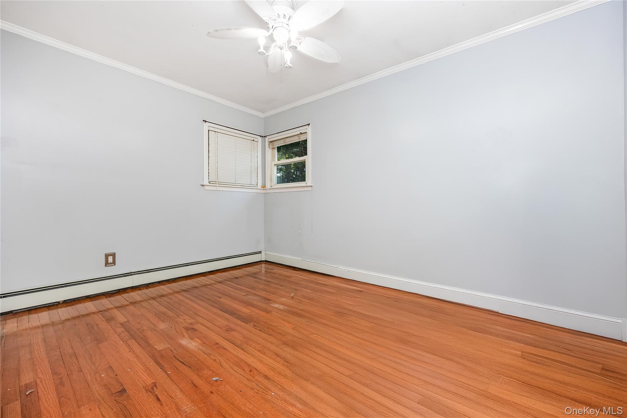 16 Hillside Road Farmingville, NY 11738 - Photo 13 of 22 wooden floor in an empty room with a window