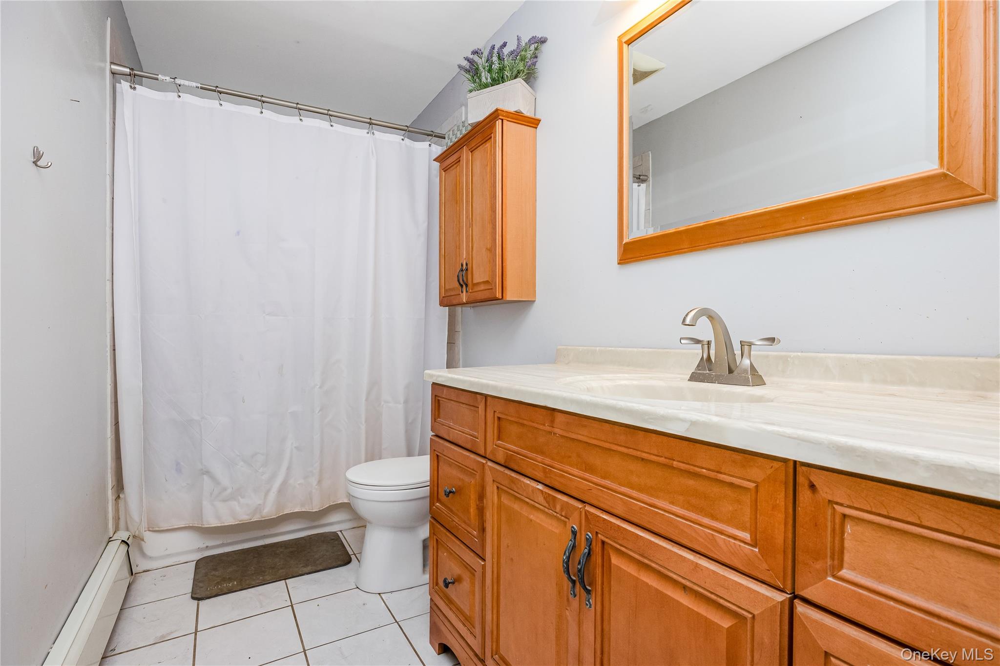 16 Hillside Road Farmingville, NY 11738 - Photo 15 of 22 a bathroom with a sink a toilet and shower