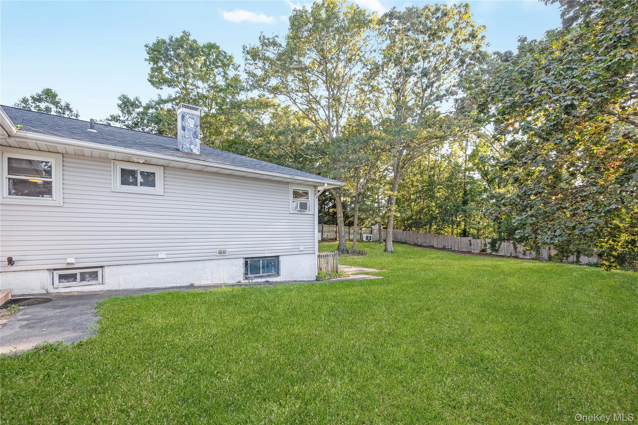 16 Hillside Road Farmingville, NY 11738 - Photo 18 of 22 a view of a backyard with a large tree