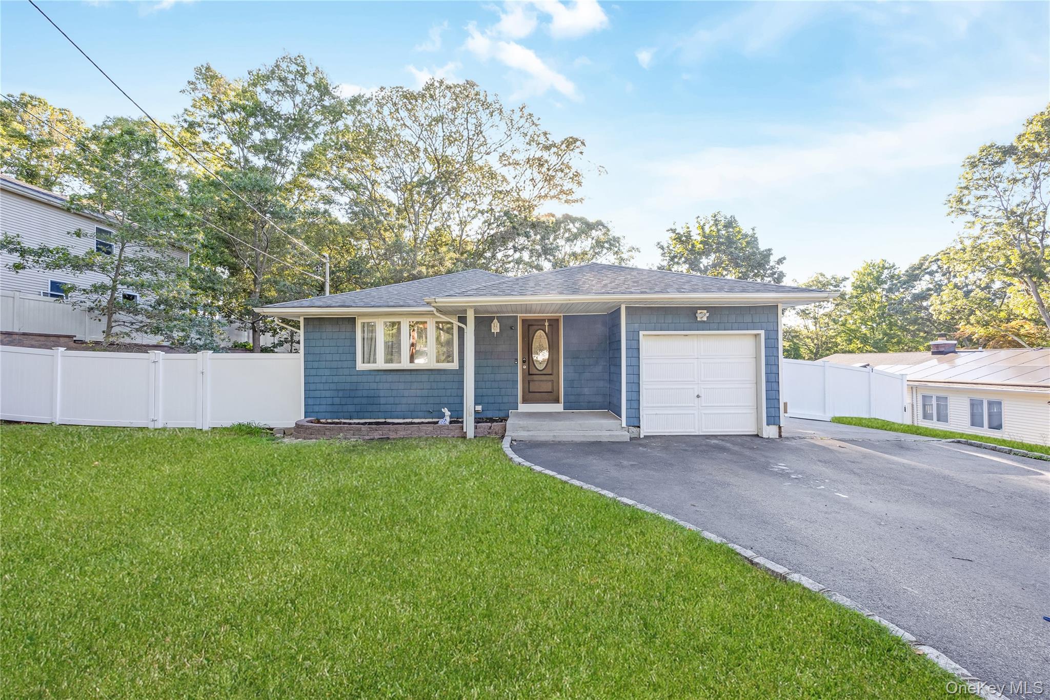 16 Hillside Road Farmingville, NY 11738 - Photo 2 of 22 front view of a house with a yard