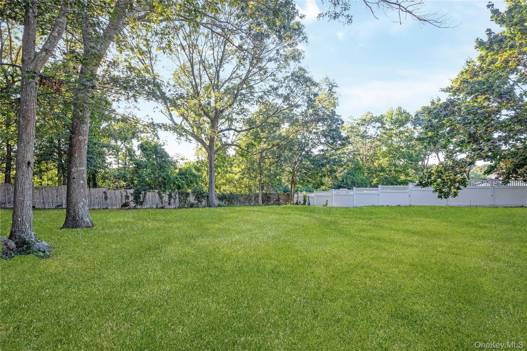 16 Hillside Road Farmingville, NY 11738 - Photo 21 of 22 a view of a field of grass and trees