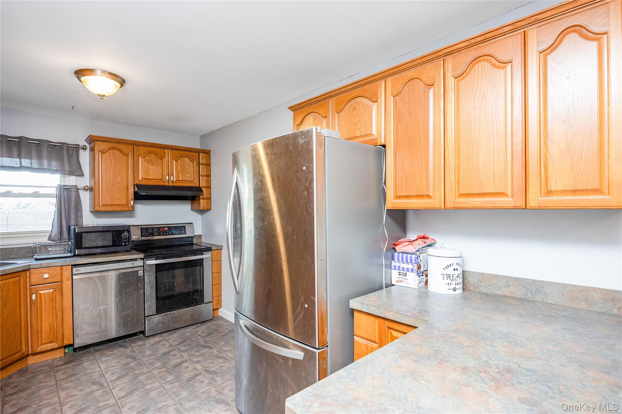 16 Hillside Road Farmingville, NY 11738 - Photo 4 of 22 a kitchen with stainless steel appliances granite countertop a refrigerator a stove top oven a sink and dishwasher