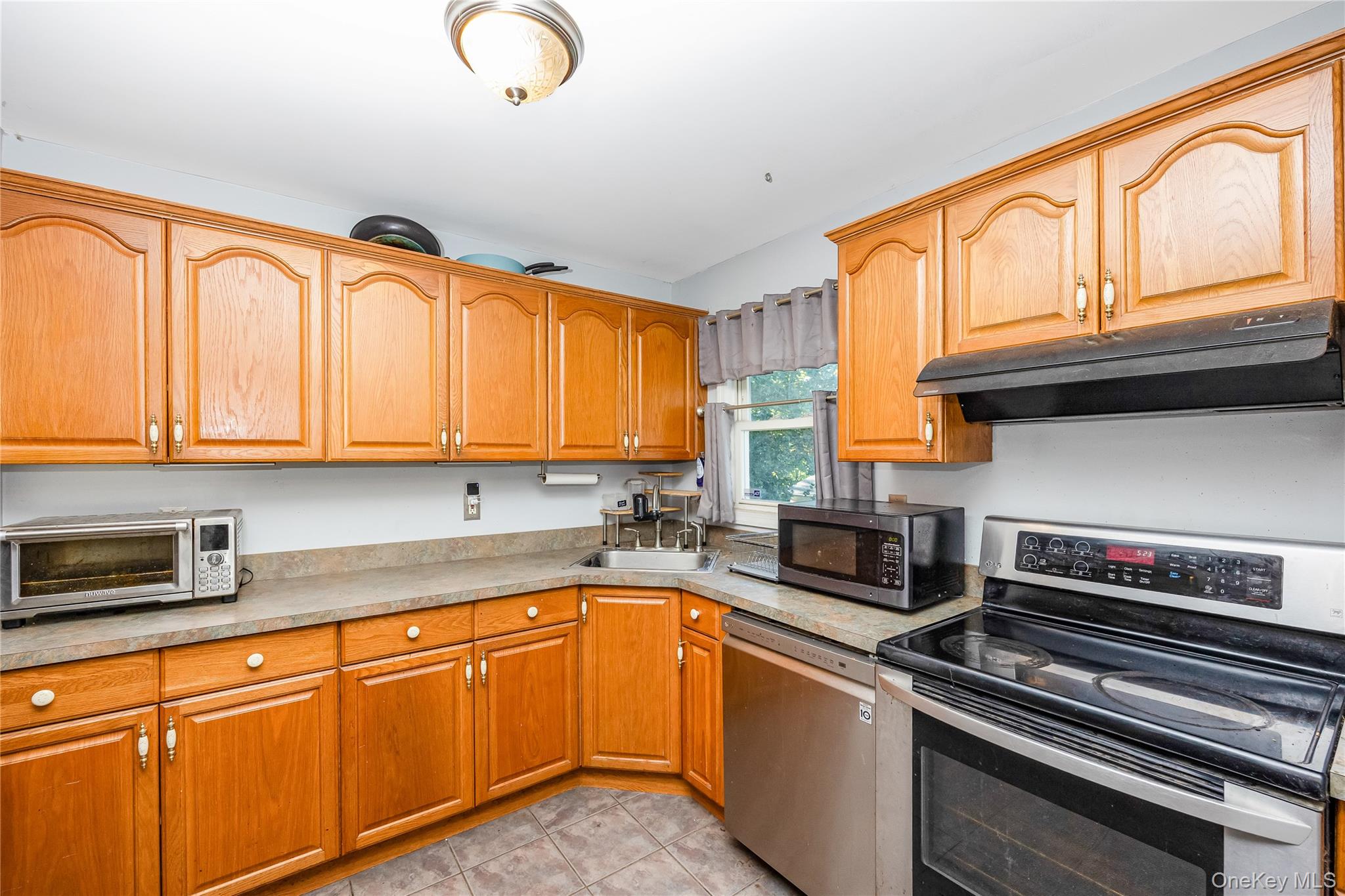 16 Hillside Road Farmingville, NY 11738 - Photo 5 of 22 a kitchen with stainless steel appliances granite countertop a stove and cabinets