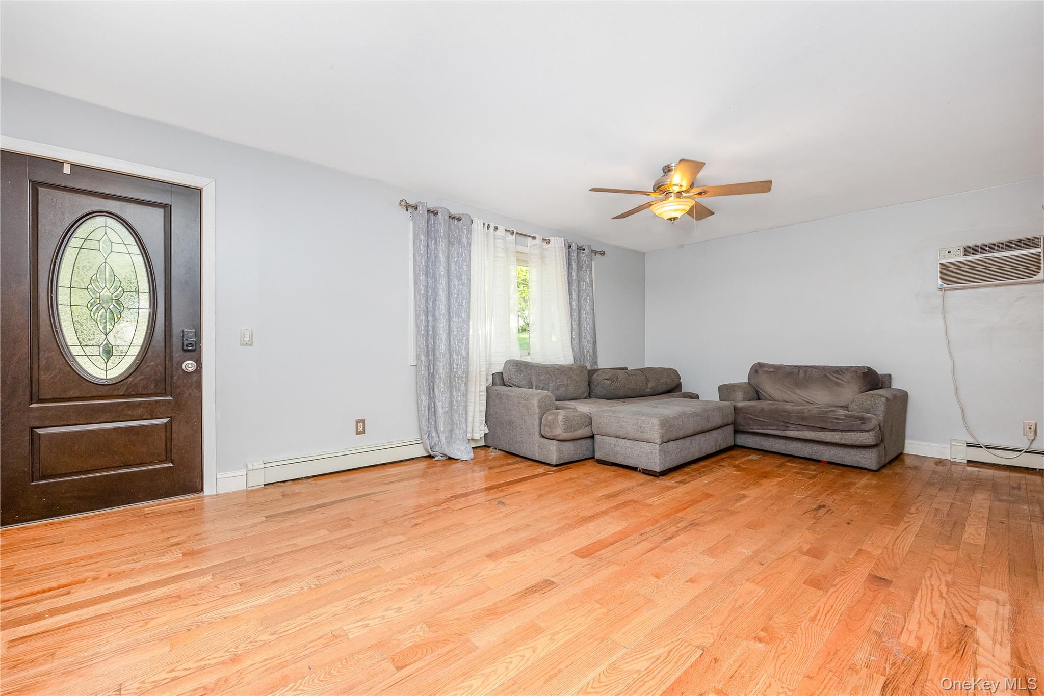 16 Hillside Road Farmingville, NY 11738 - Photo 7 of 22 a living room with furniture and a window