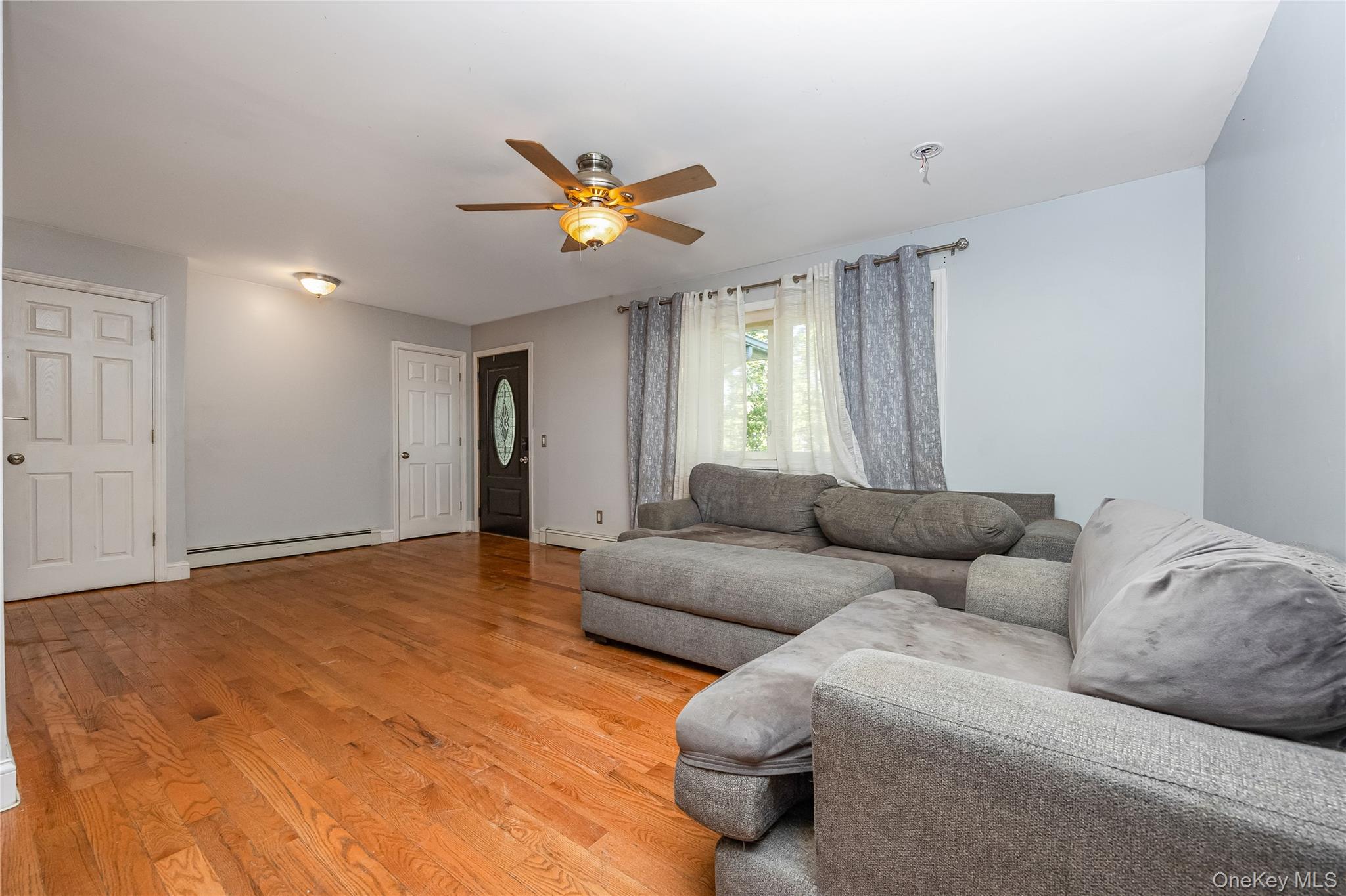 16 Hillside Road Farmingville, NY 11738 - Photo 9 of 22 a living room with furniture and a window